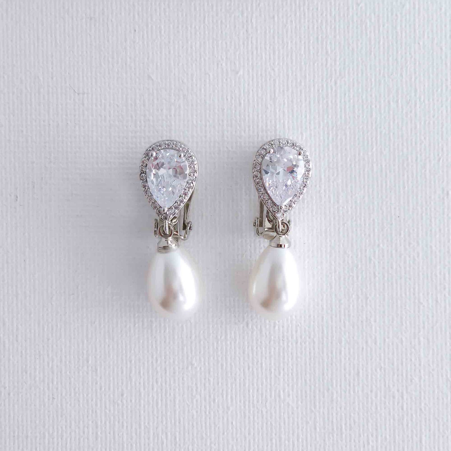 Pair of pearl and crystal drop earrings on a light gray background- Clipon's