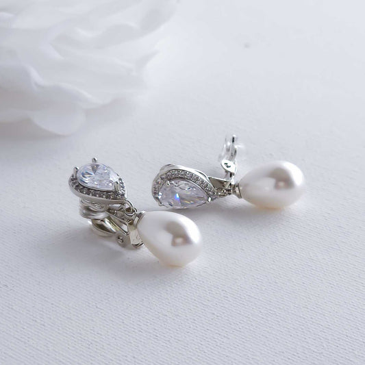 Pearl and crystal earrings on a light background