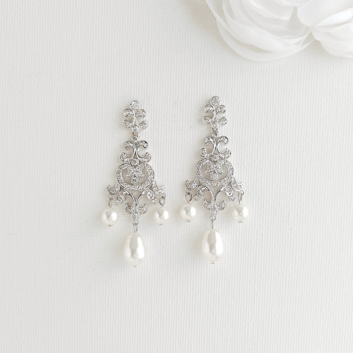 Lightweight silver vintage style pearl drop chandelier earrings featuring cubic zirconia and flawless round crystal pearls.