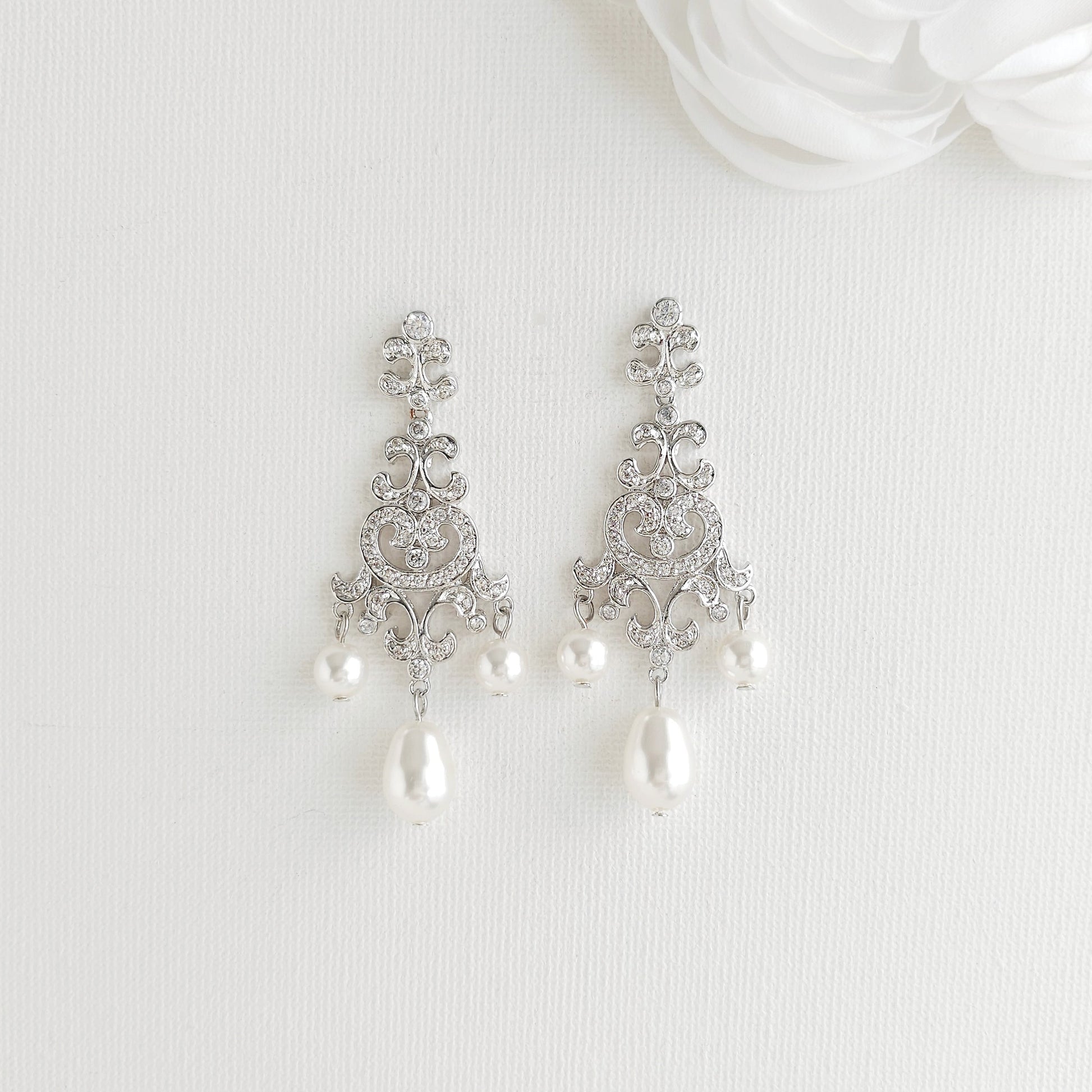 Lightweight silver vintage style pearl drop chandelier earrings featuring cubic zirconia and flawless round crystal pearls.