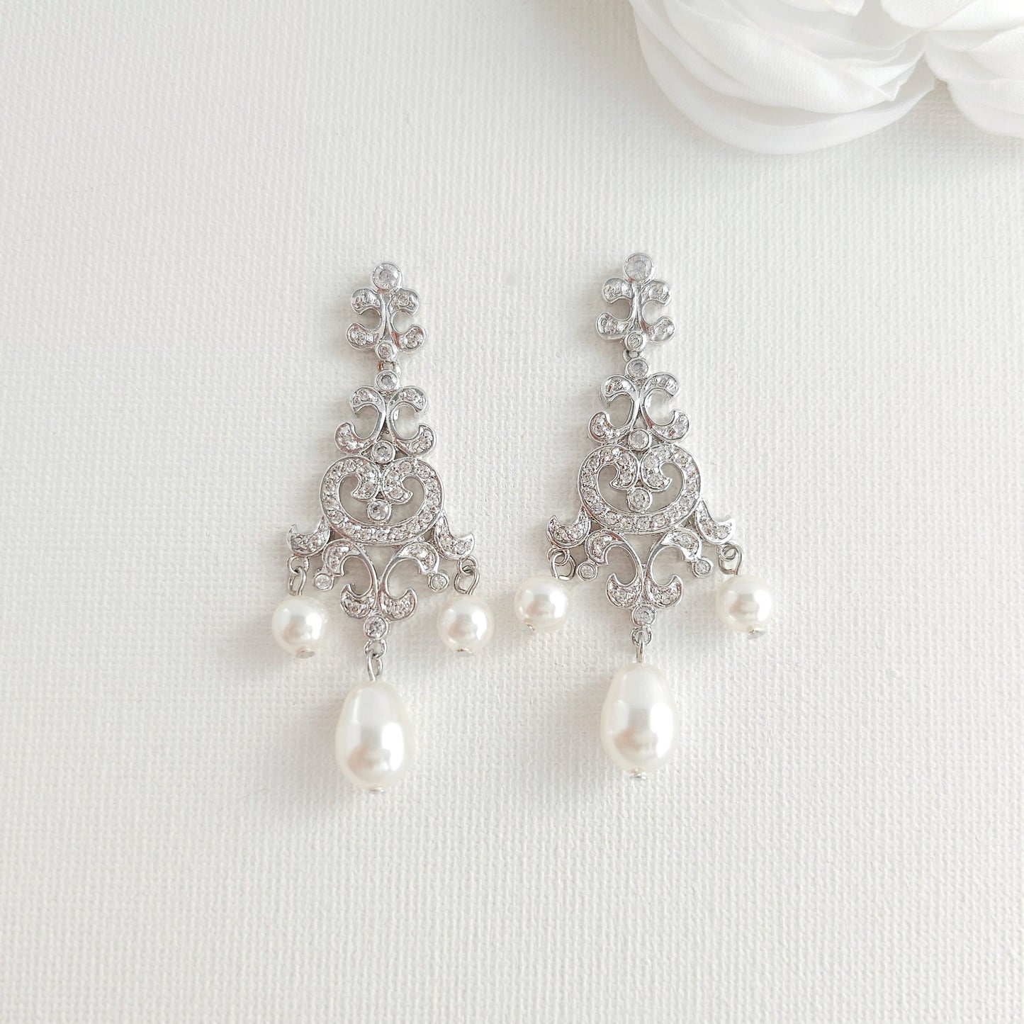 Lightweight silver vintage style pearl drop chandelier earrings featuring cubic zirconia and flawless round crystal pearls.