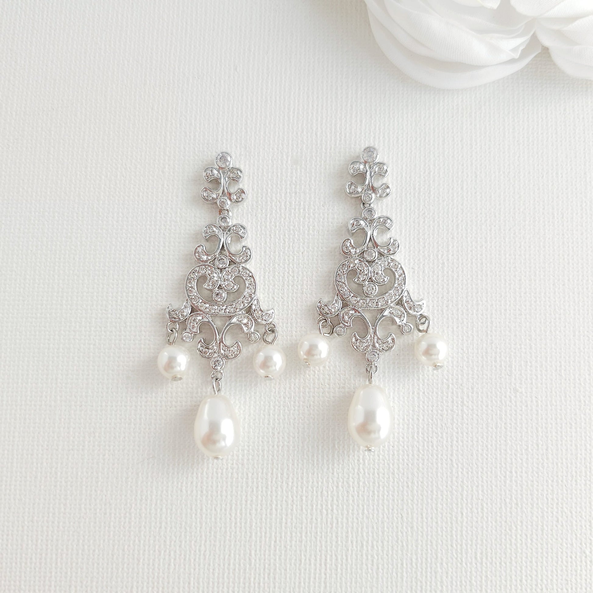 Lightweight silver vintage style pearl drop chandelier earrings featuring cubic zirconia and flawless round crystal pearls.