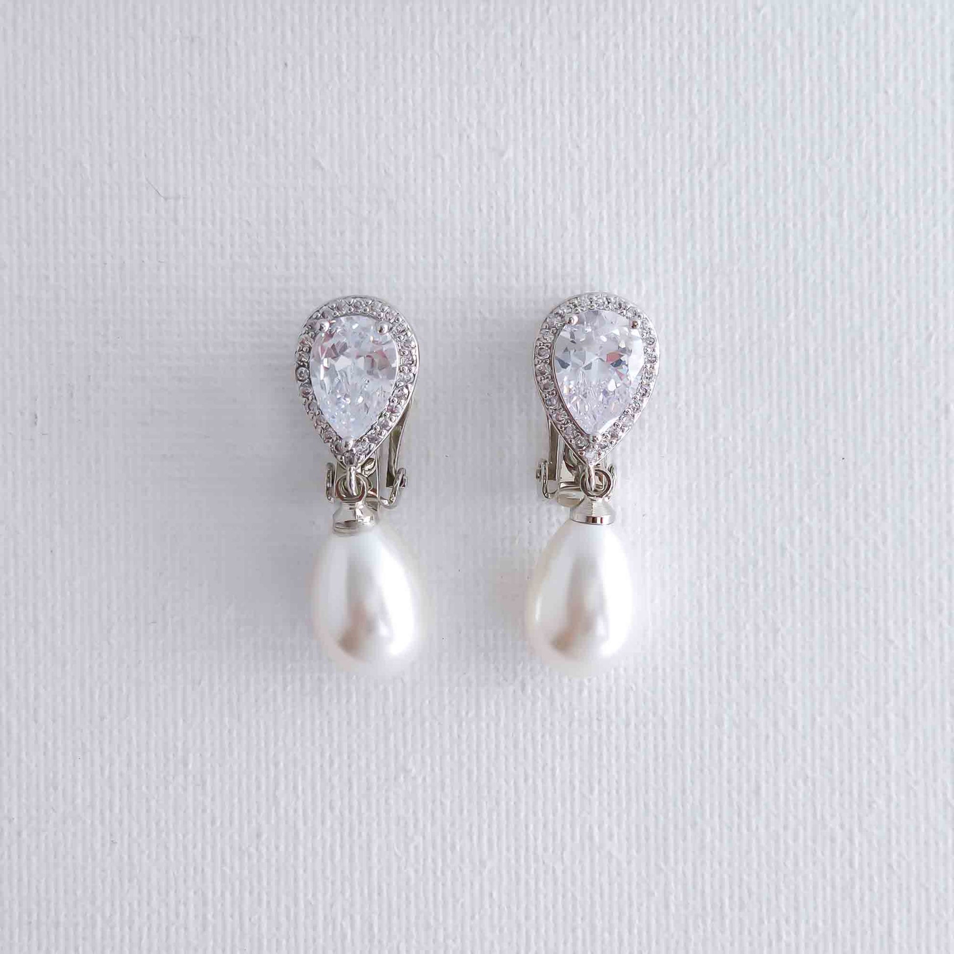 Pair of pearl and crystal drop earrings on a light gray background- Clipon's