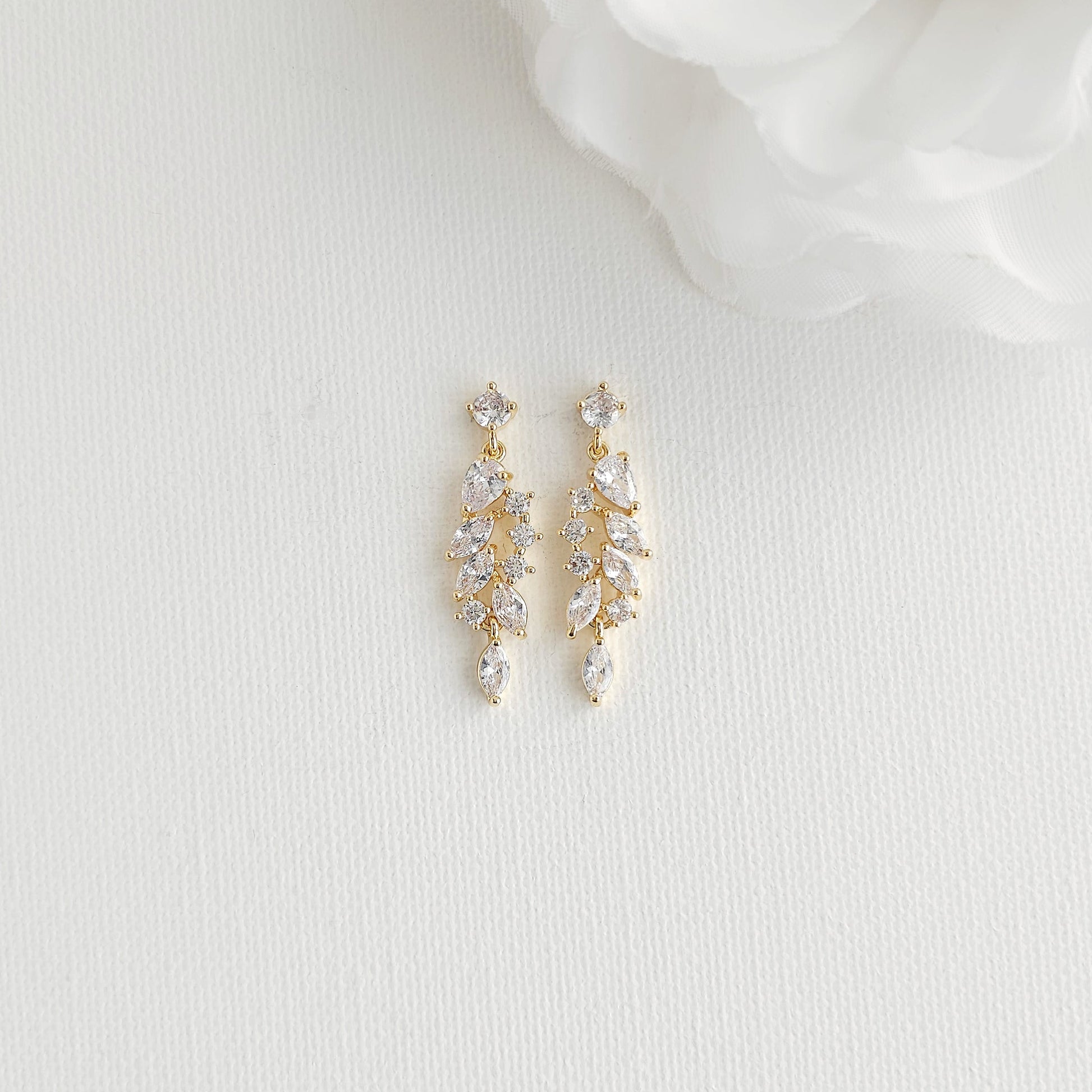 A pair of gold drop earrings with clear marquise and round-cut CZ 