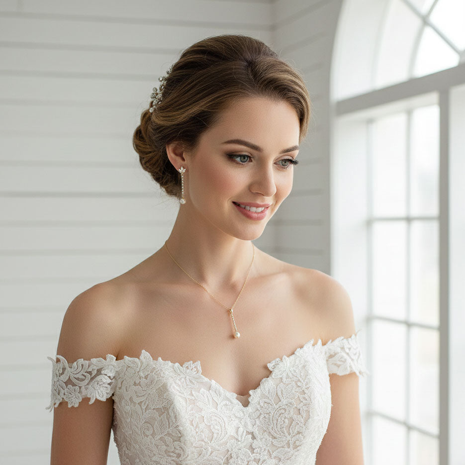Woman wearing a Pearl Drop Earrings in Rose Gold and wedding dress with a neutral background