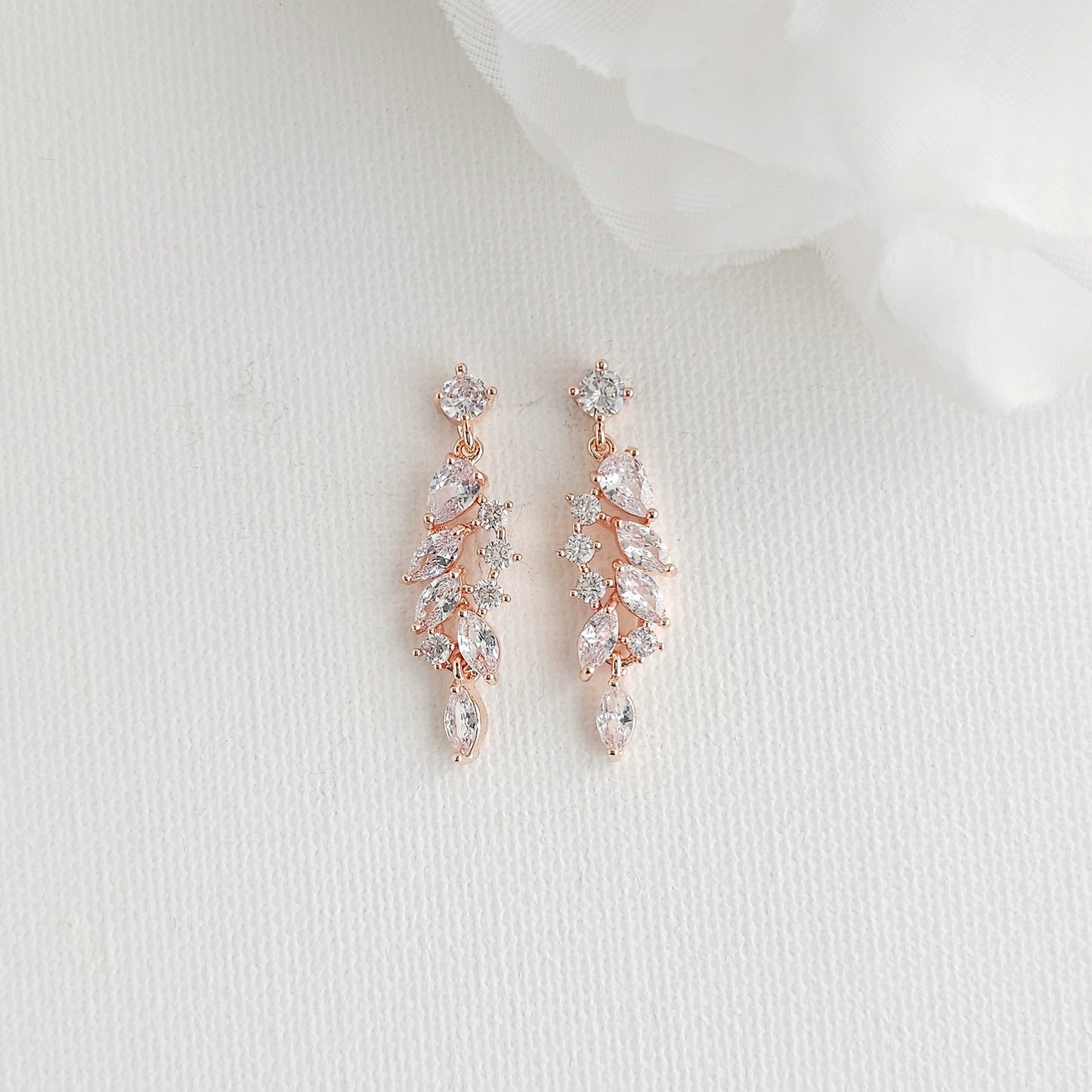 Delicate rose gold leaf drop earrings featuring an articulated marquise cubic zirconia cluster, perfect for blush, champagne, and ivory gowns.
